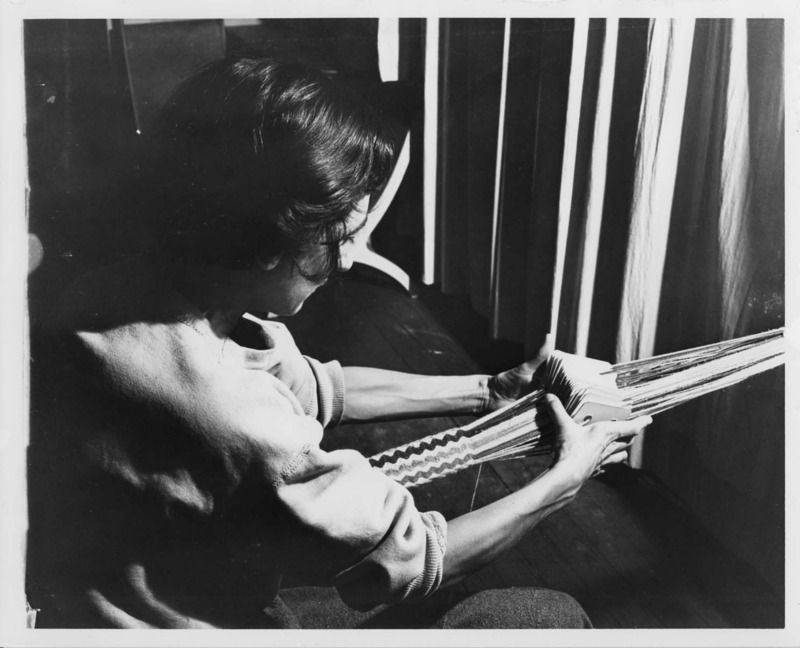 Photograph of Anni Albers card weaving at Black Mountain College. Anni Albers taught Weaving and Textile Design at Black Mountain College from 1933-1949.