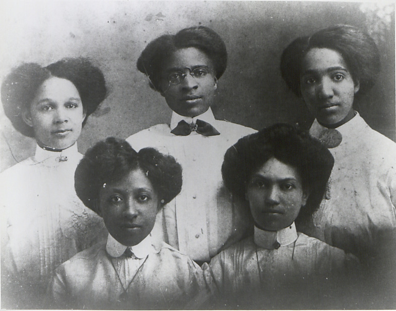 This photograph depicts five Palmer Memorial Institute (PMI) teachers. PMI was established in 1902 by Dr. Charlotte Hawkins Brown at Sedalia, North Carolina near Greensboro. The African American school evolved from an agricultural and manual training facility to a fully accredited, nationally recognized preparatory school. More than 1,000 students graduated during Brown&#39;s 50-year presidency. The school closed its doors in the 1970s, but the campus reopened in 1987 as North Carolina&#39;s first African American state historic site and a memorial to Dr. Brown.