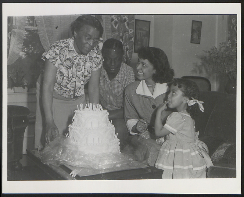 Dr. Charlotte Hawkins Brown with Nat King, Maria, and Cookie Cole celebrating a birthday. Maria Cole was the niece of Dr. Brown.