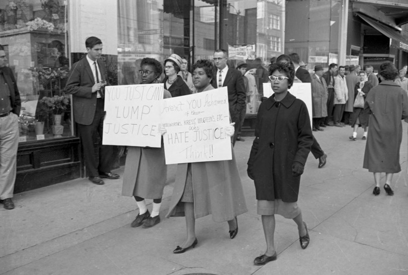 African American women picketers holding signs calling for justice.