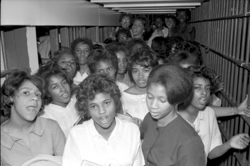 African American women protesters crowded into a jail cell.